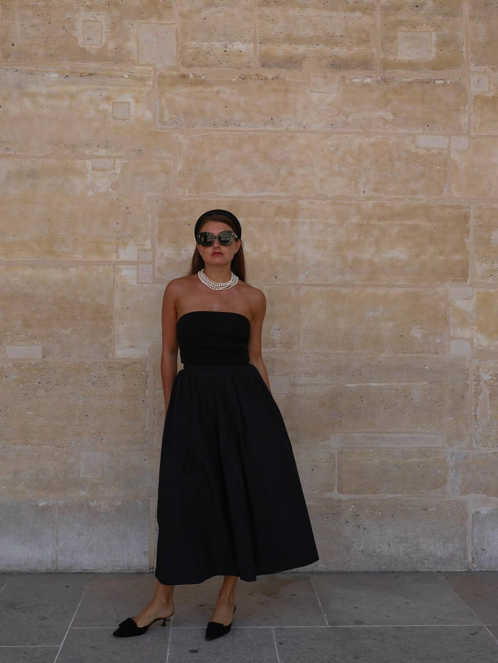 Femme portant un serre-tête Raphia Paris dans un look chic